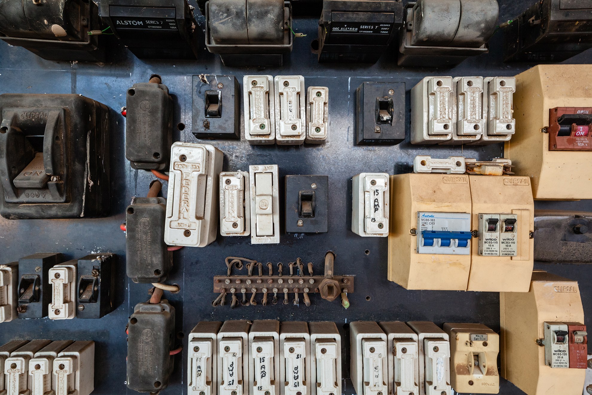 old domestic electrical switchboard and fuses, circuit breakers, switches, and ceramic fueses