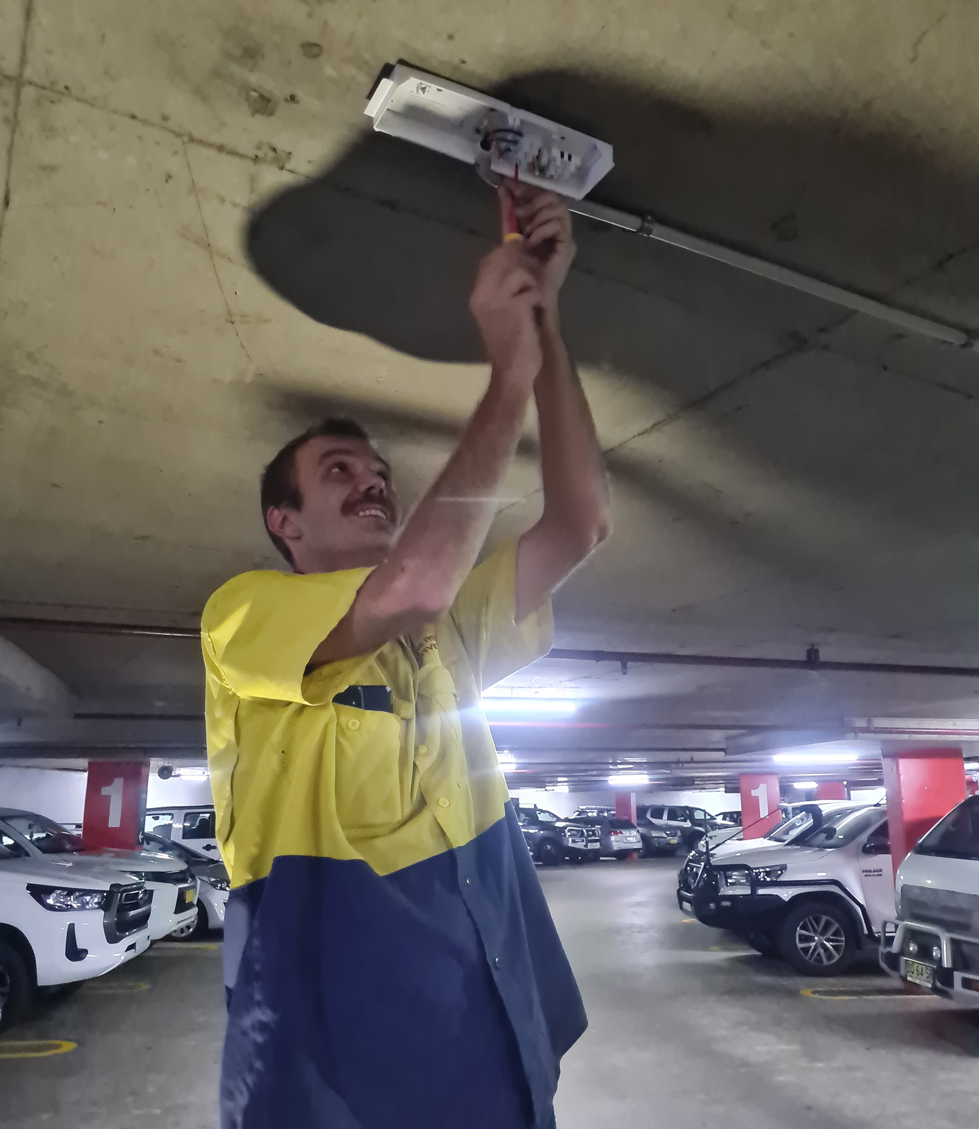 car park lighting upgrades - WR8TECh Electrician working on lighting upgrade at the domain car park in Sydney