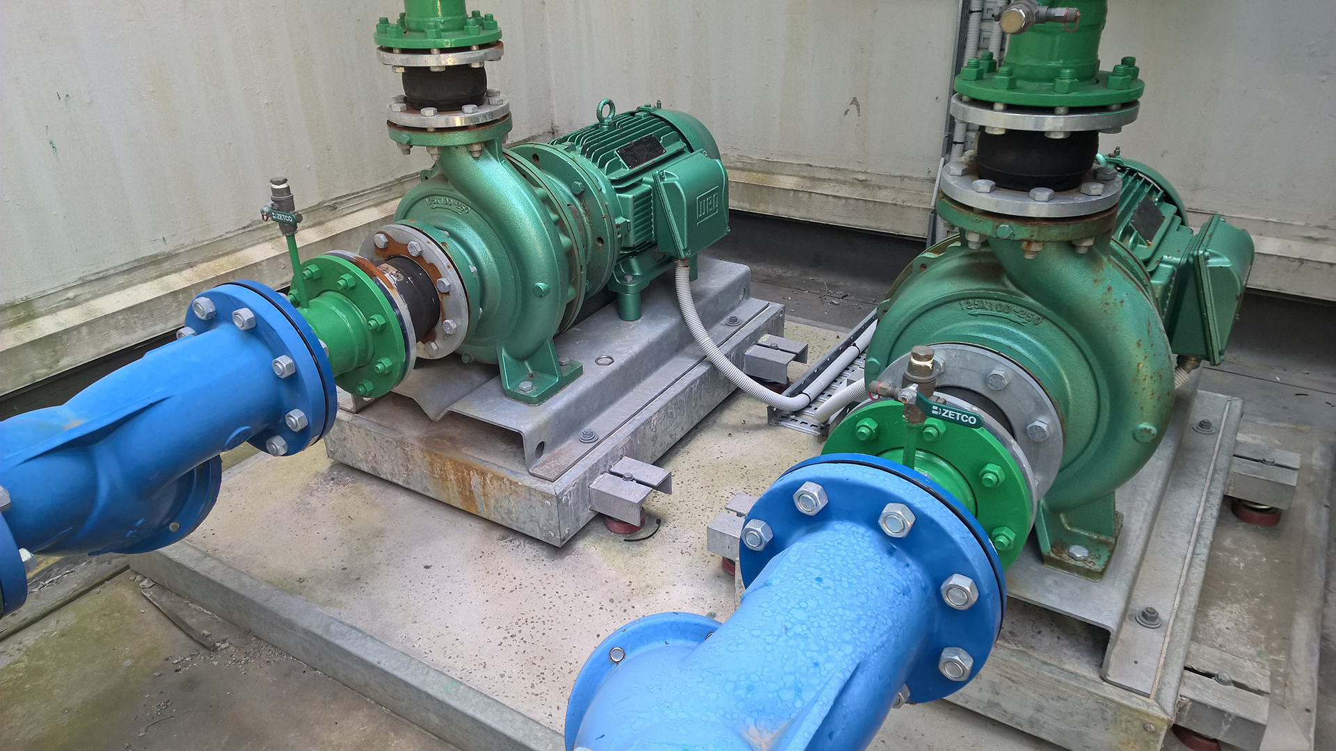 two condenser water pumos in a open rooftop plant room in Margaret Street in Sydney, these pumps are controlled via an Alerton BMS