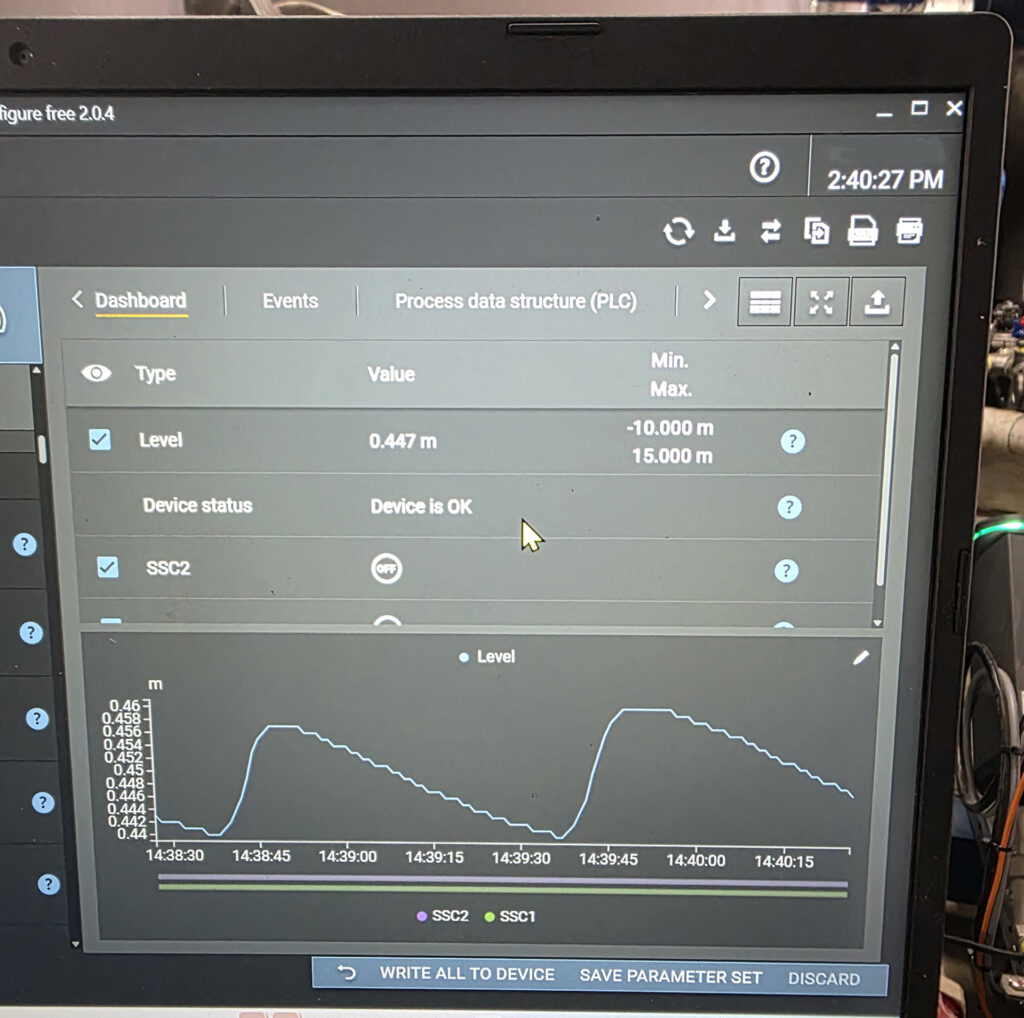 Laptop displaying live level readings and a trend graph from an ifm LW2120 level sensor during expansion tank commissioning by WR8Tech.