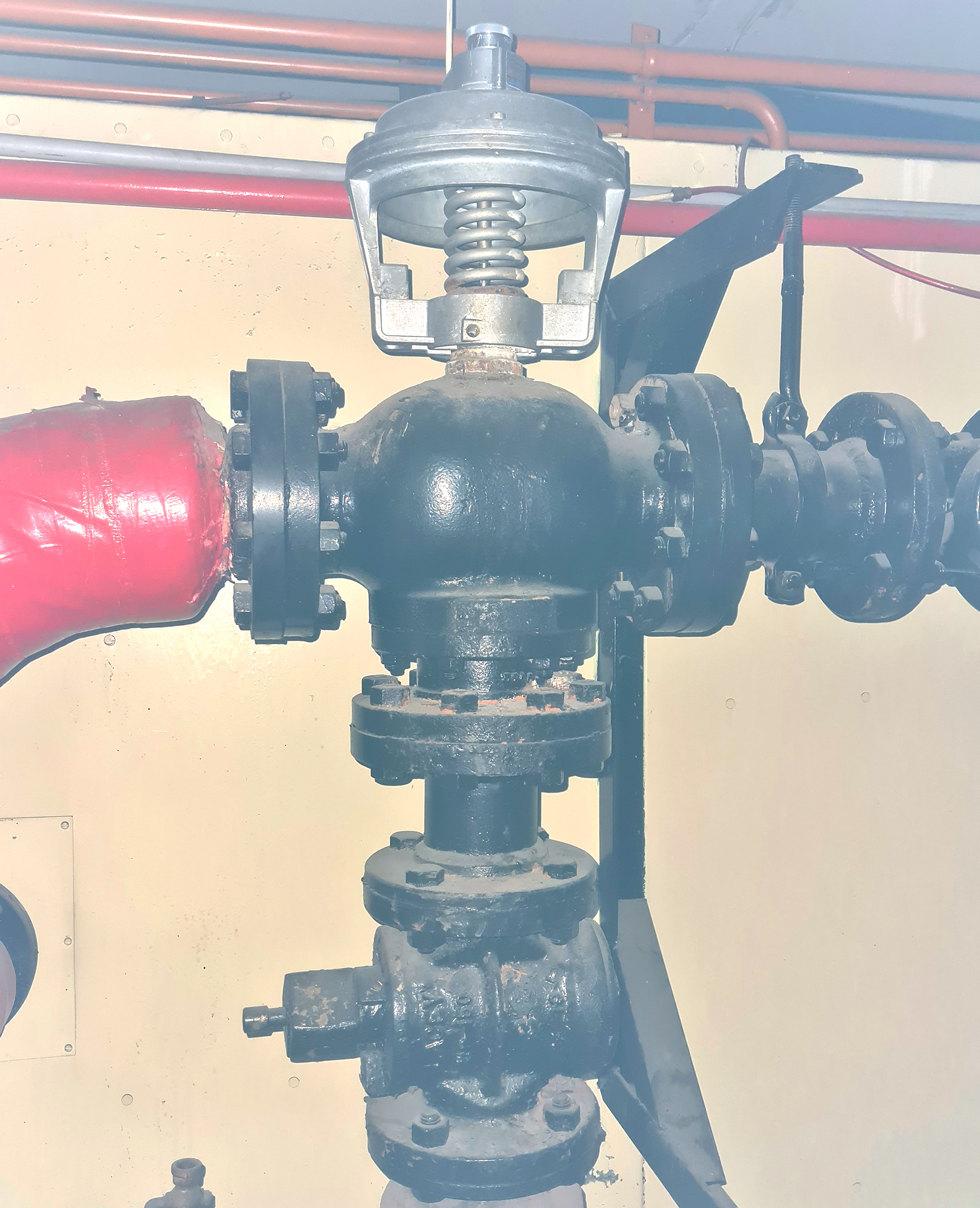We can see in the picture an older-style HVAC mixing box arrangement, with the heating duct entering from one side and the cooling duct from the other. An internal damper modulates between the two air streams to maintain the required discharge air temperature. The damper operation is controlled by a pneumatic actuator responding to a wall-mounted pneumatic room sensor or thermostat, which varies the air pressure signal based on room temperature demand.