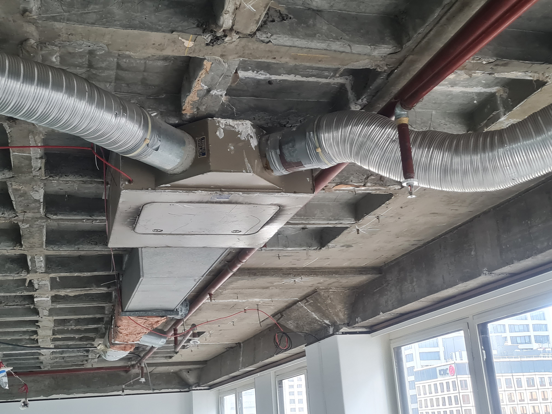 We can see in the picture an older-style HVAC mixing box arrangement, with the heating duct entering from one side and the cooling duct from the other. An internal damper modulates between the two air streams to maintain the required discharge air temperature. The damper operation is controlled by a pneumatic actuator responding to a wall-mounted pneumatic room sensor or thermostat, which varies the air pressure signal based on room temperature demand.