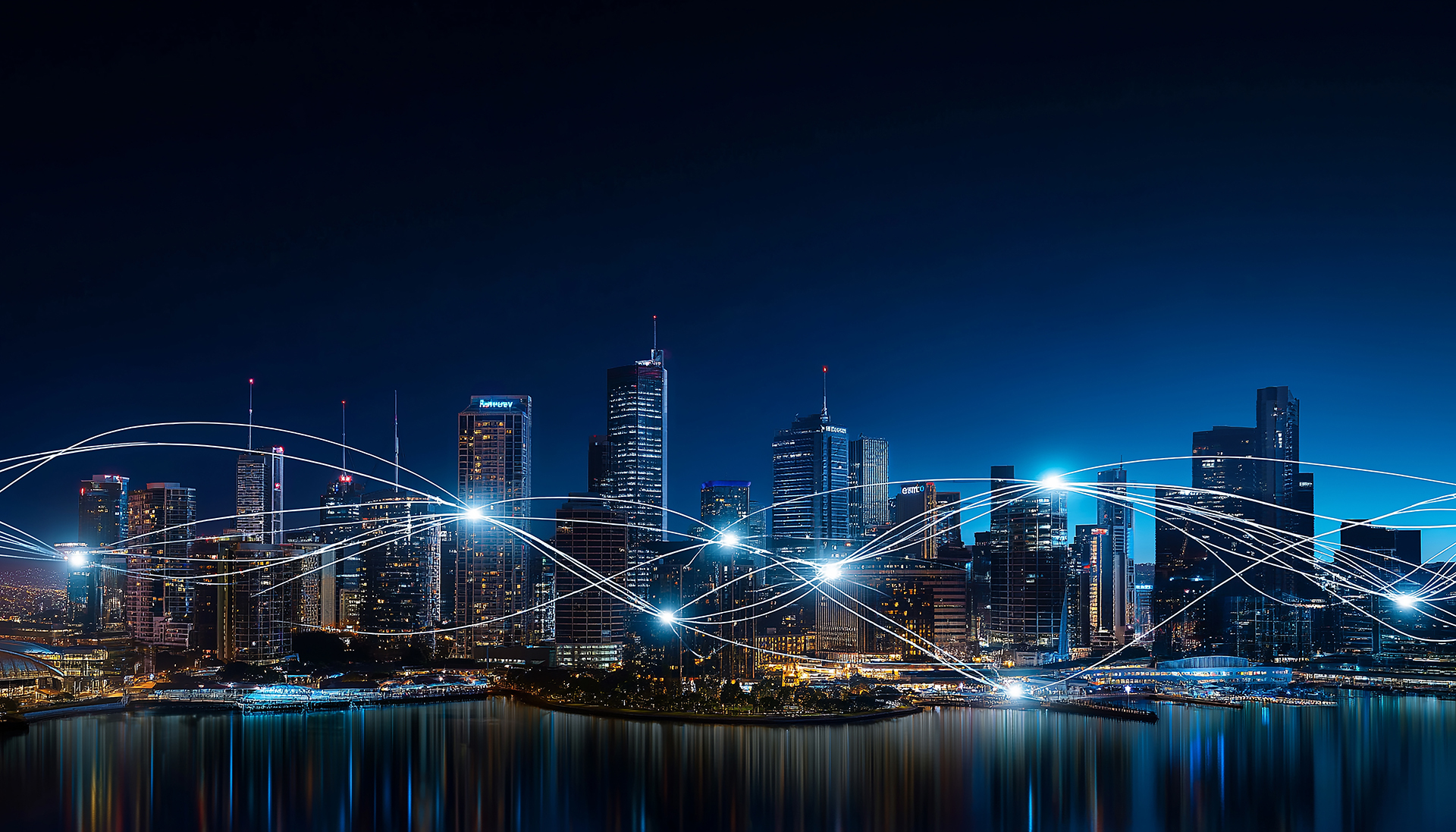 Sydney Harbour at night with illuminated buildings and landmarks connected by glowing network lines across the city skyline, representing smart building technology, building management systems, connectivity, and digital infrastructure.