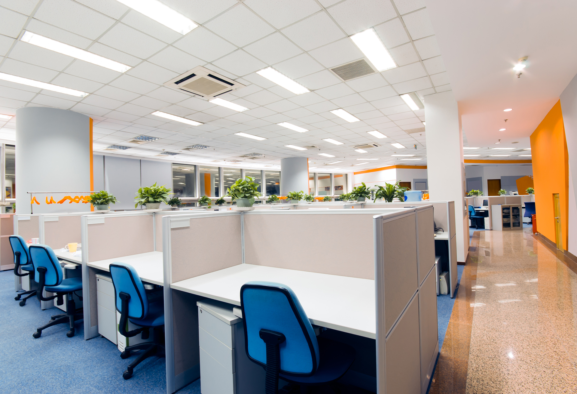 Modern commercial office fitted with energy-efficient LED lighting and intelligent lighting controls providing comfortable workplace illumination.