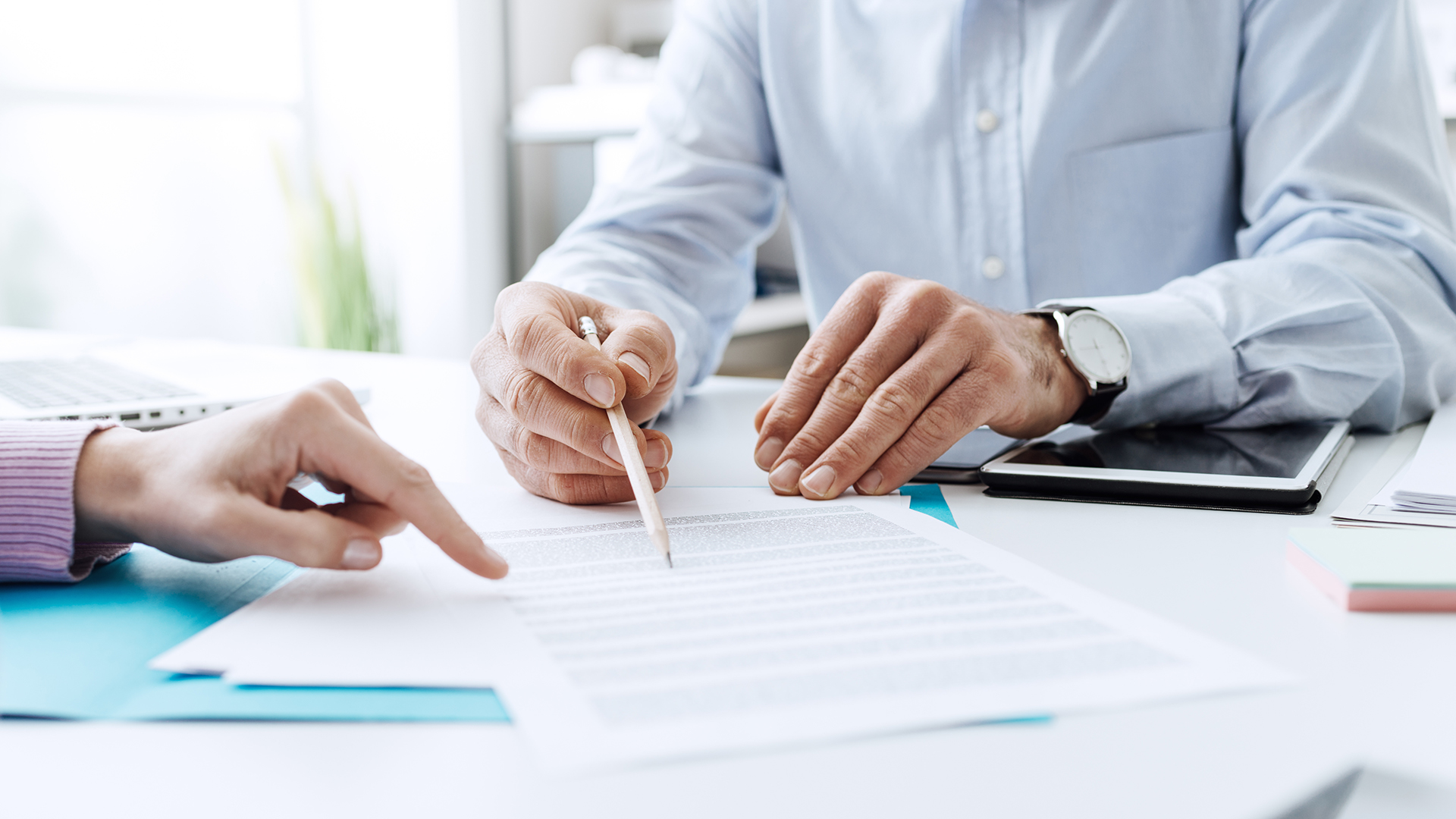 tw executives at a desk reviewing documentation