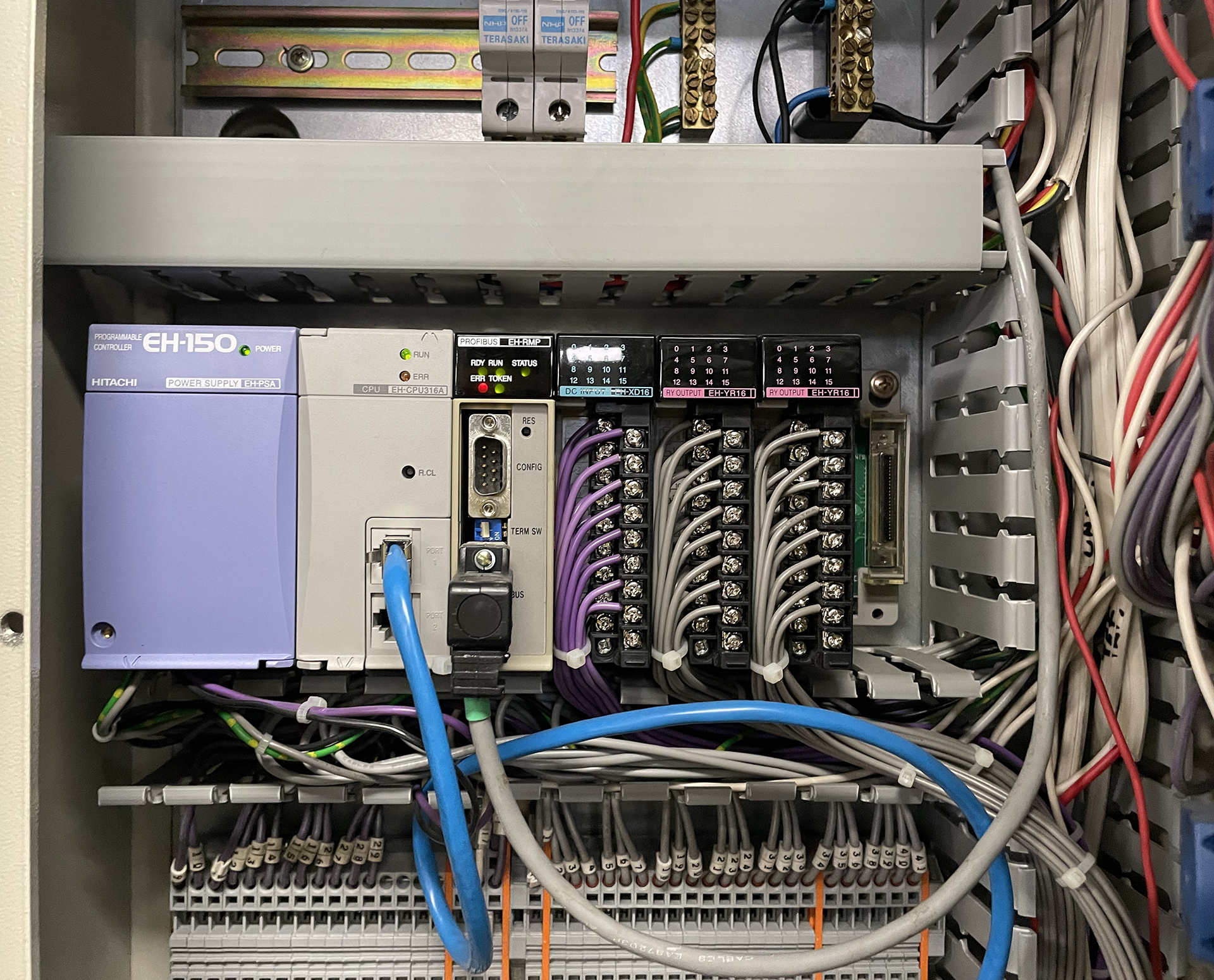 Hitachi EH-150 PLC controlling a commercial carbon monoxide ventilation system inside a basement car park control panel.