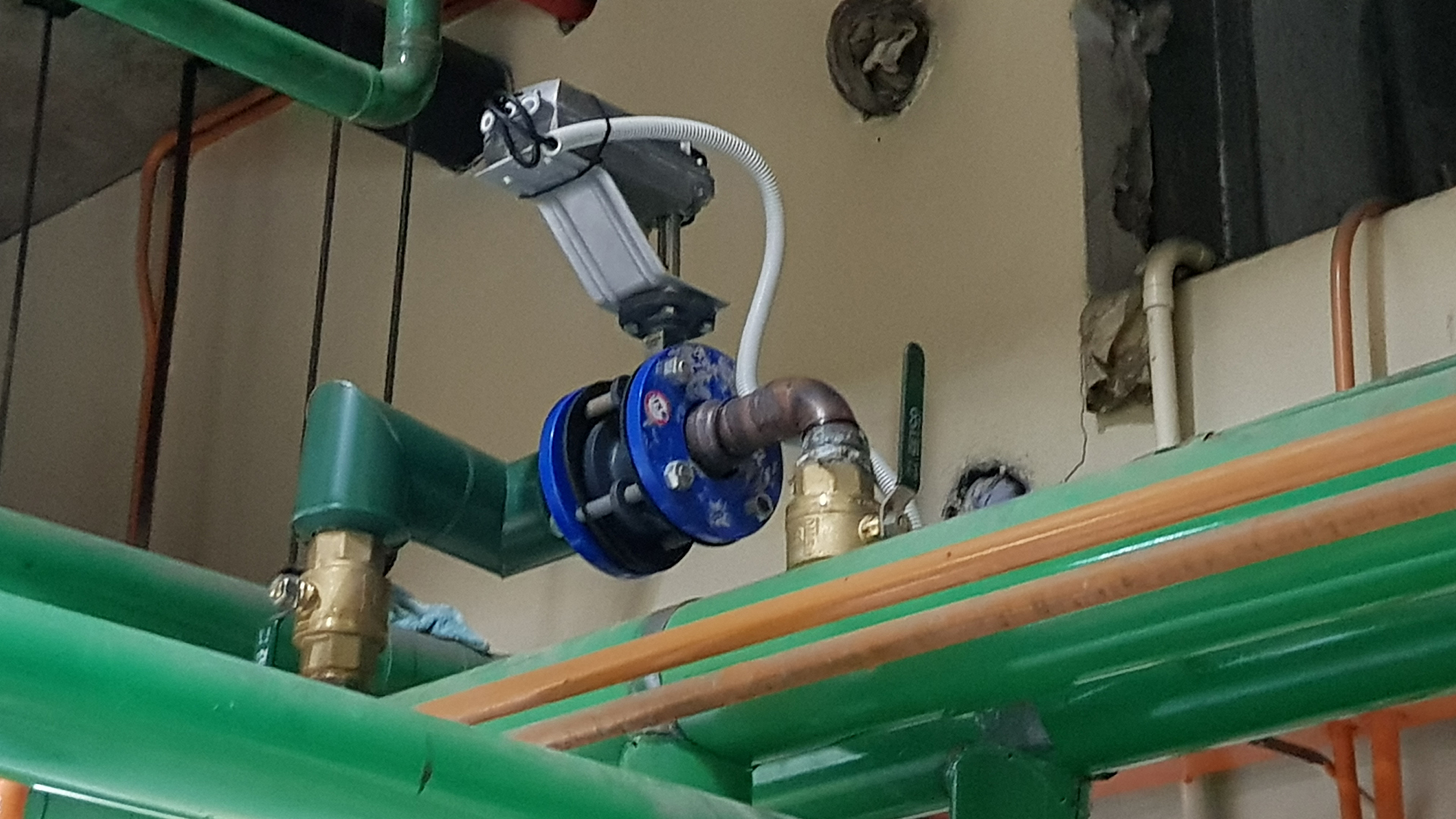 Motorised two-way butterfly valve with electric actuator and adaptor plate connected to a Building Management System in a Sydney commercial building.
