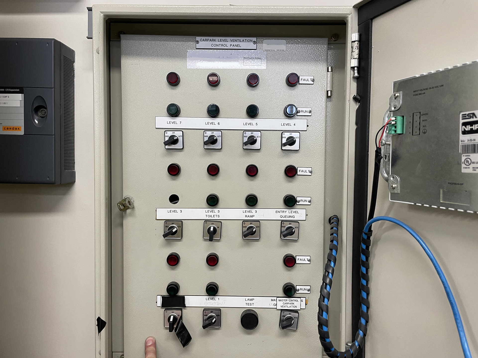 Remote control panel for a commercial basement car park carbon monoxide ventilation system showing Auto, Off and Manual fan controls with run and fault indicators.