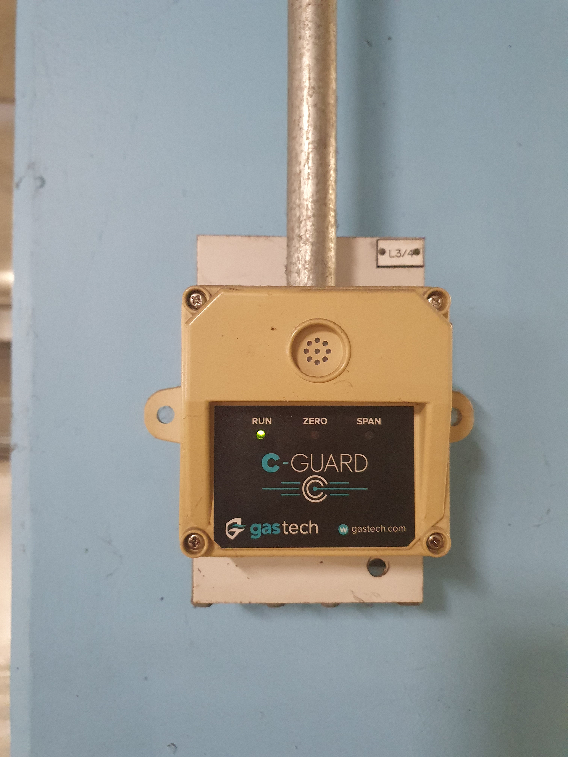Commercial basement car park carbon monoxide sensor monitoring CO levels for automatic ventilation fan control.