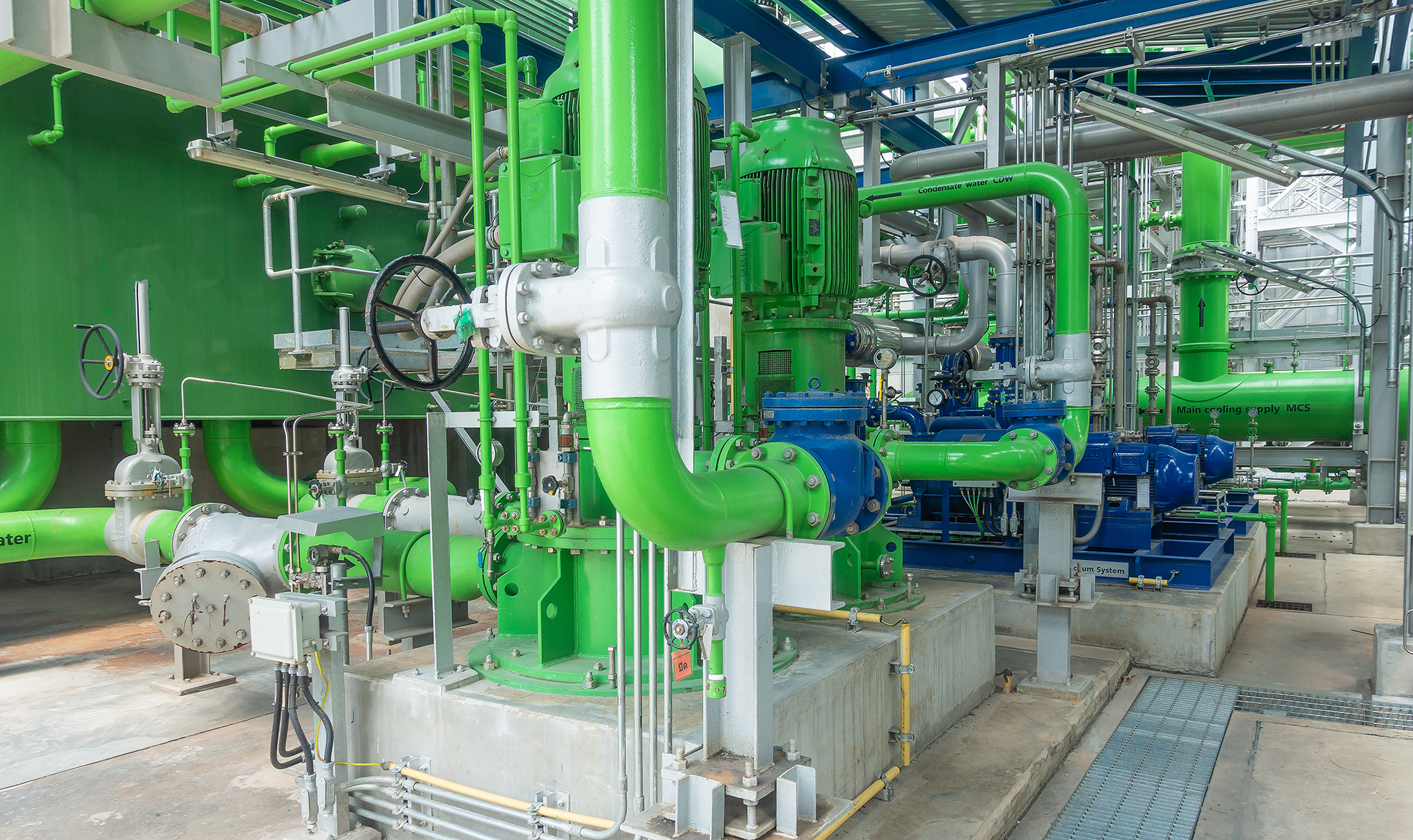 Commercial chilled water plantroom featuring large pumps, insulated pipework, valves and mechanical services equipment installed as part of a commercial HVAC project.