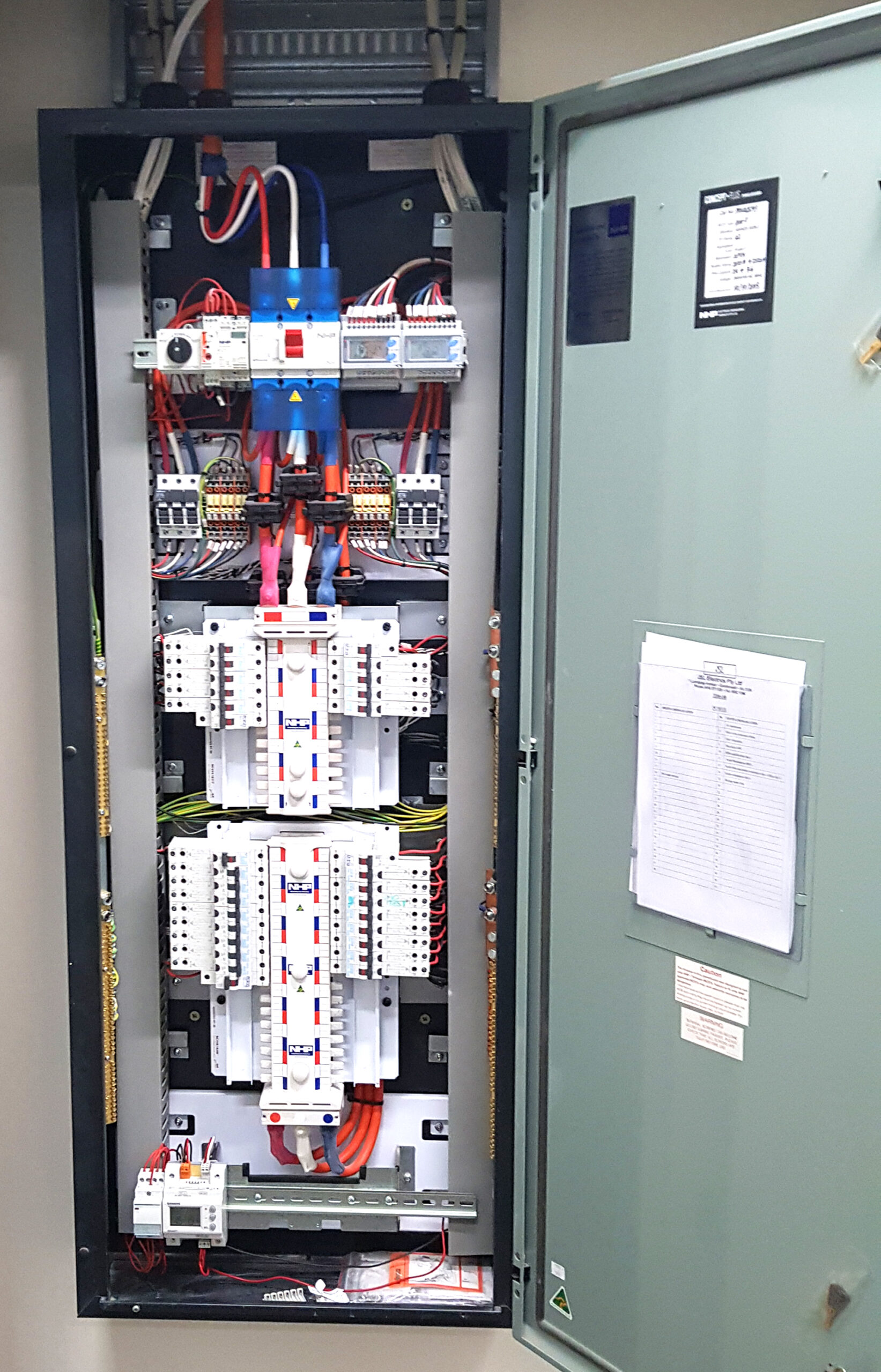 Open commercial electrical distribution switchboard showing main switch, distribution busbars, circuit breakers and outgoing electrical circuits supplying a commercial office tenancy.