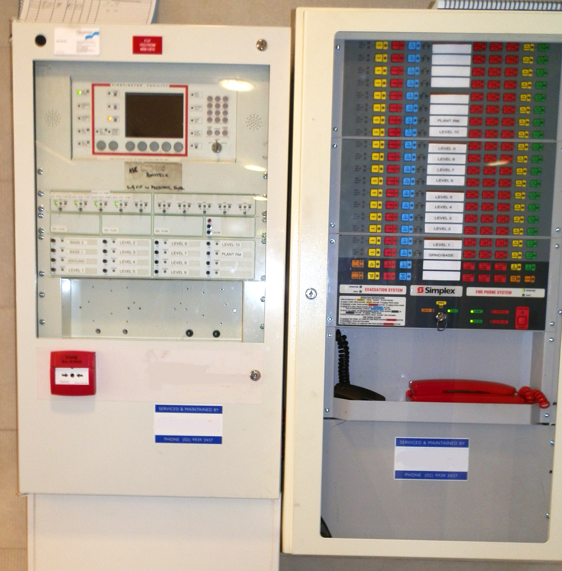 Fire Indication Panel beside an Emergency Warning and Intercommunication System (EWIS) control panel in a Sydney commercial building used for fire detection, evacuation management and emergency communications.