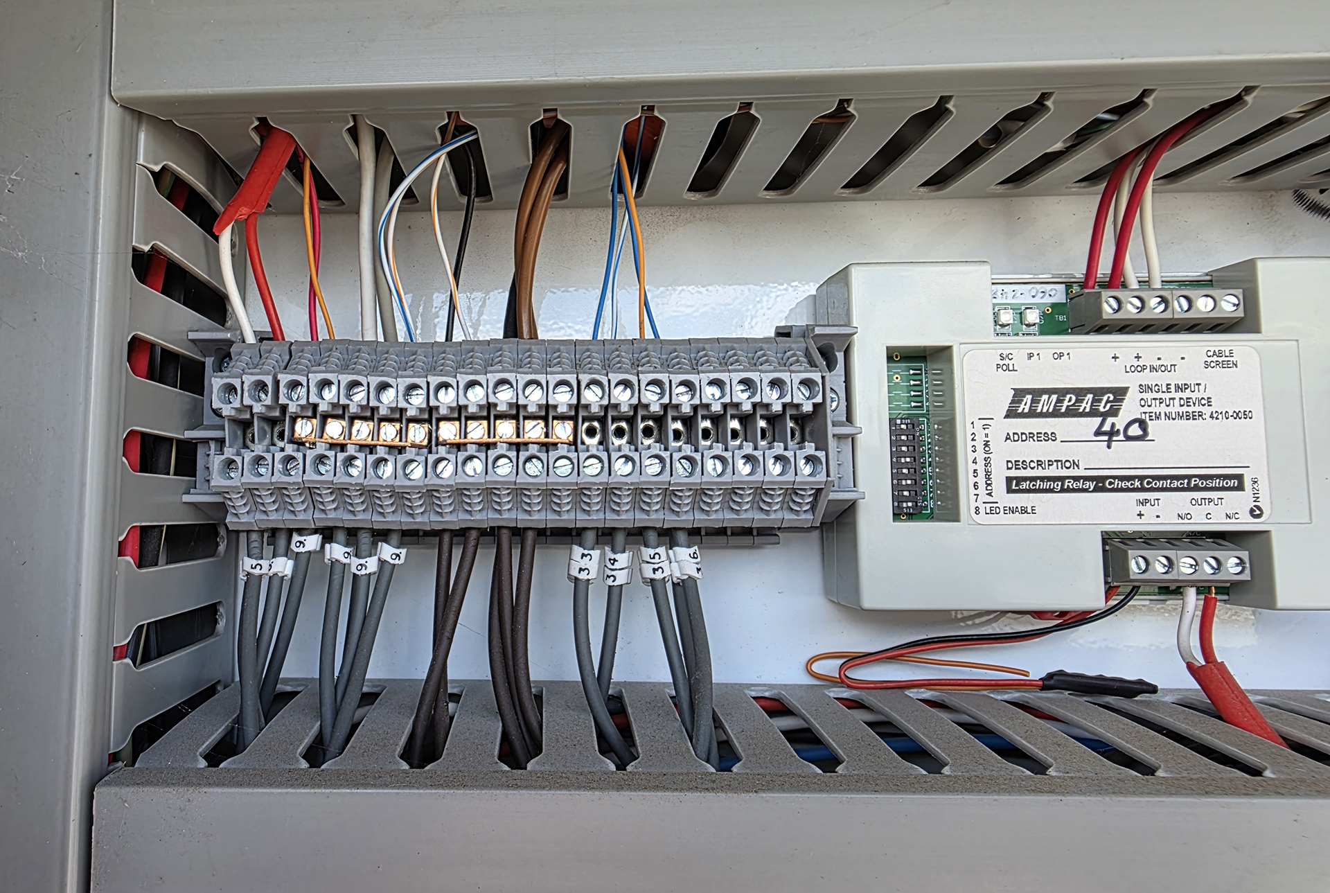 AMPAC fire system interface module and terminal strip providing HVAC fire trip and control signals between a Fire Indication Panel and a Mechanical Services Switchboard.