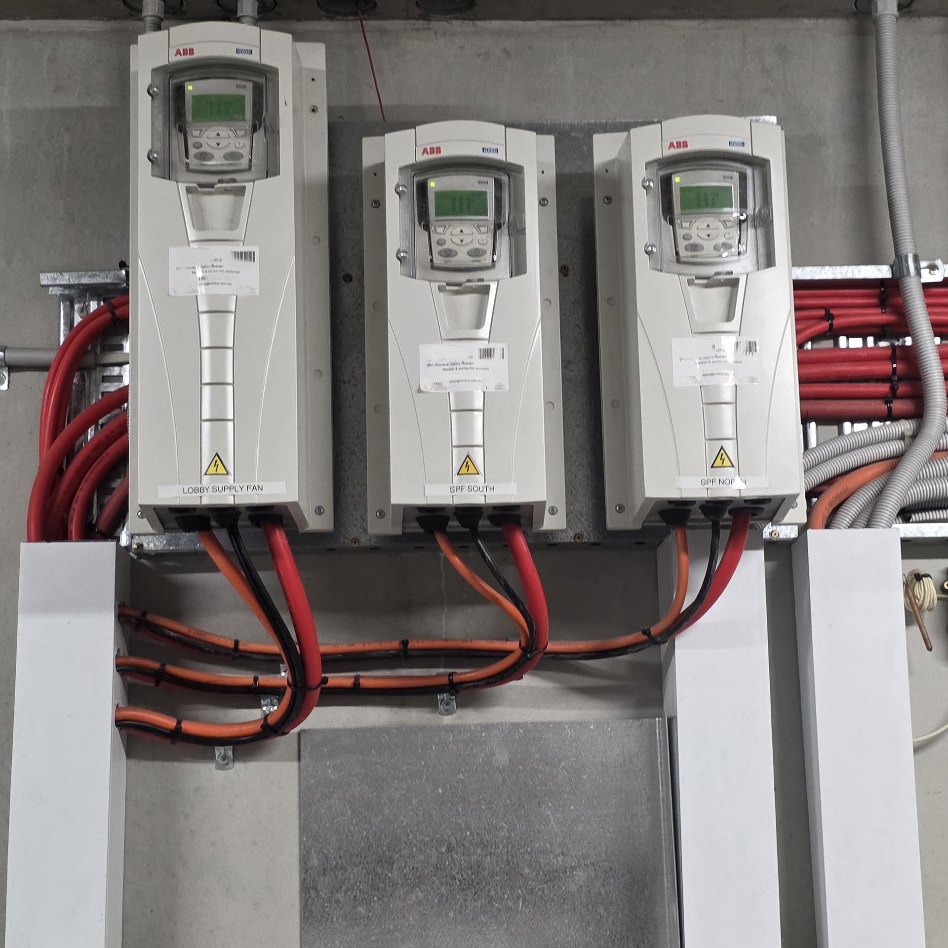 three ABB Variable Speed Drives mountd on a plant room wall serving car park exhaust and supply fans in Sydney Suburb apartment block