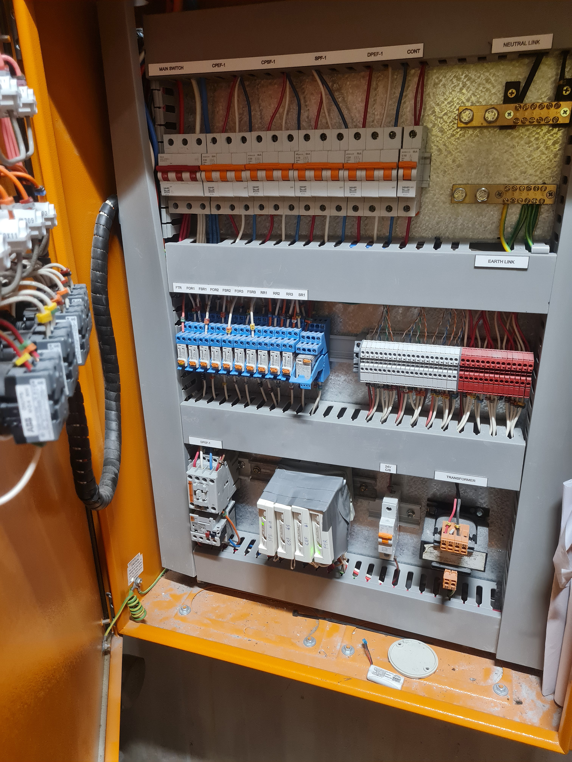 Mechanical Services Switchboard showing Fire Indication Panel interface relays and control modules for HVAC shutdown and smoke control.