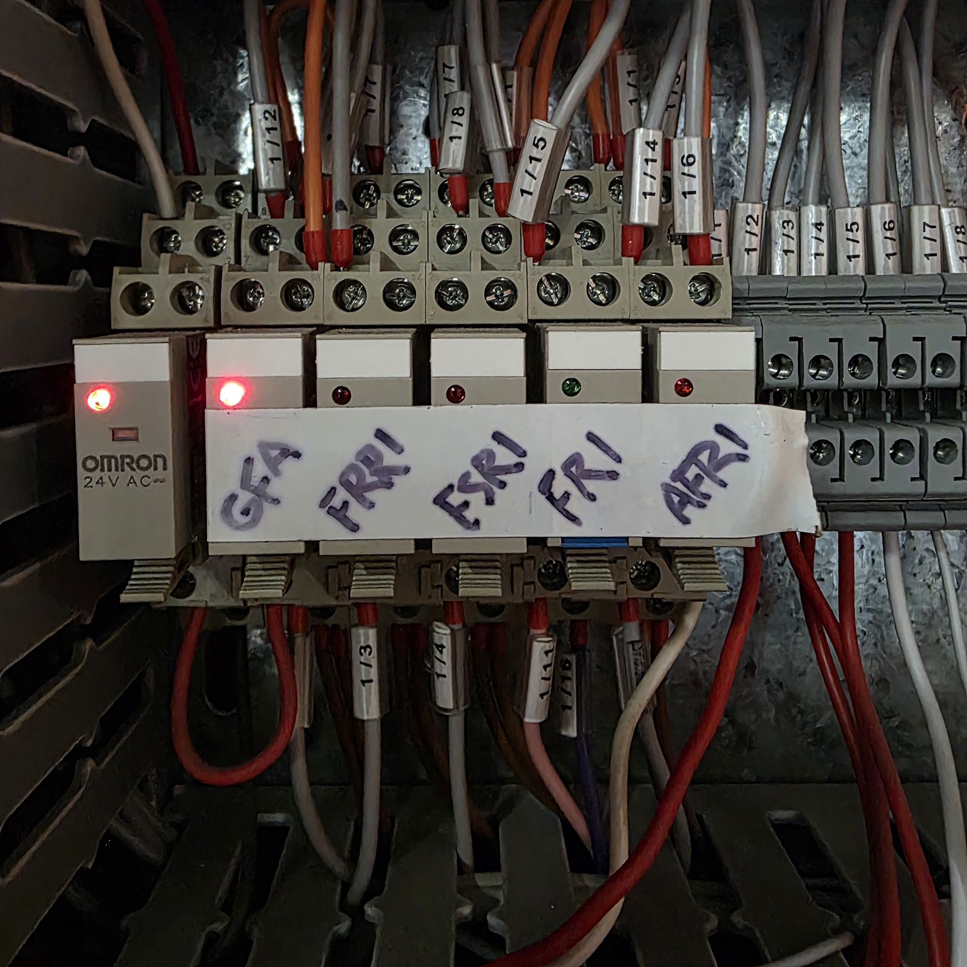 Mechanical services control relays inside an essential switchboard being inspected during a commercial HVAC fault-finding investigation.