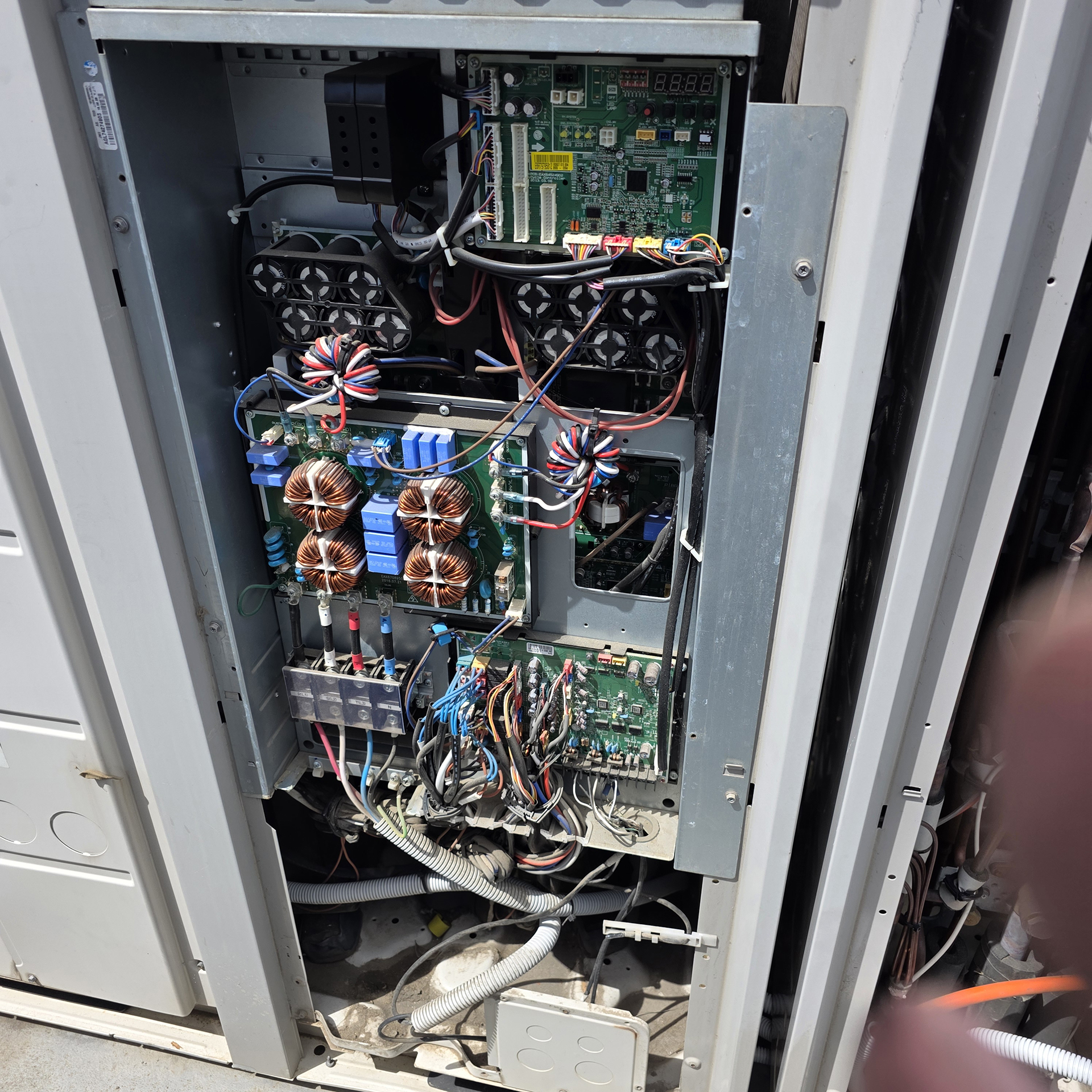 Commercial VRV air conditioning system opened during fault finding investigation with inverter electronics and control boards exposed.