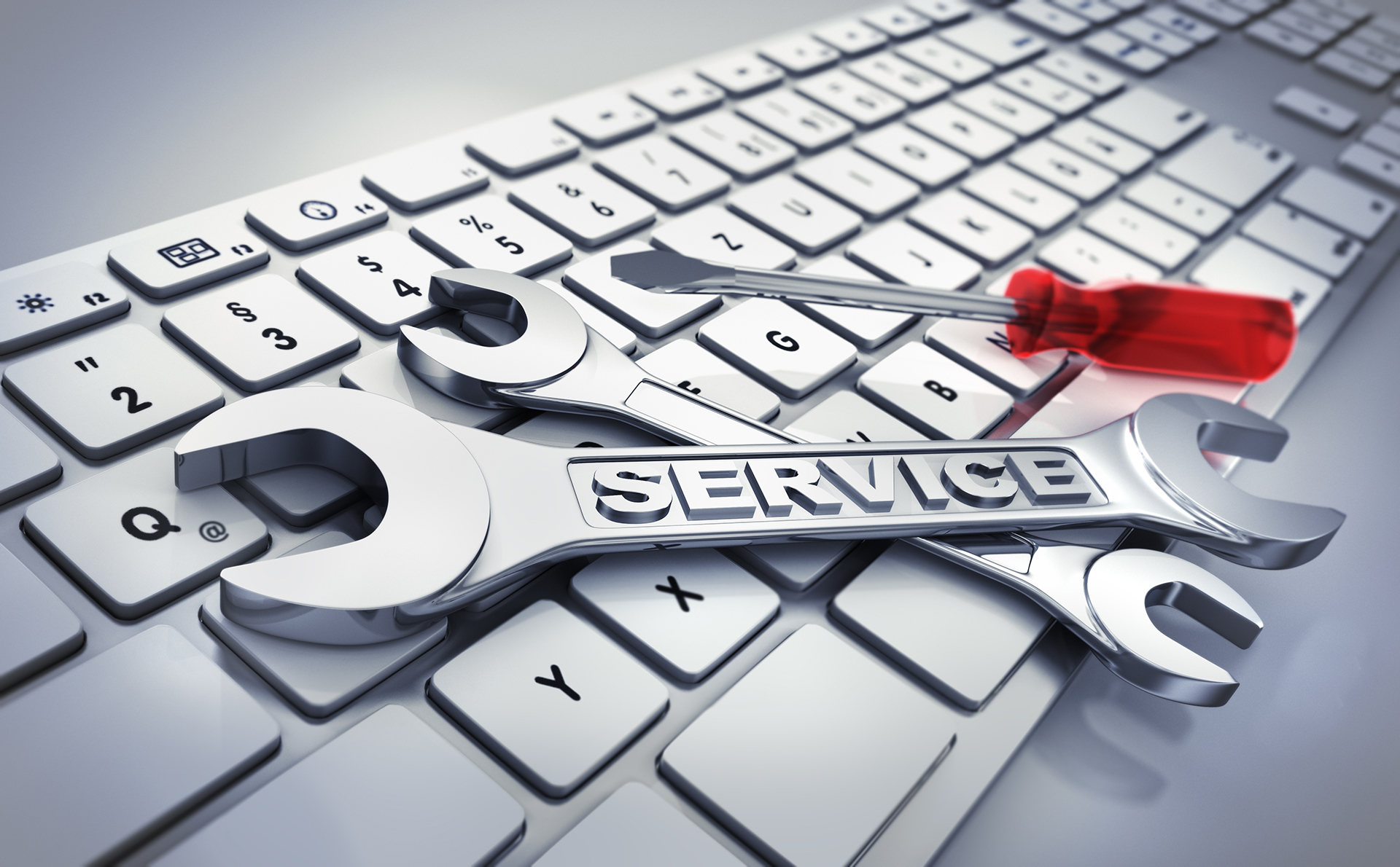 Computer keyboard with spanners showing the relationship between hard services and soft services in Facility Management