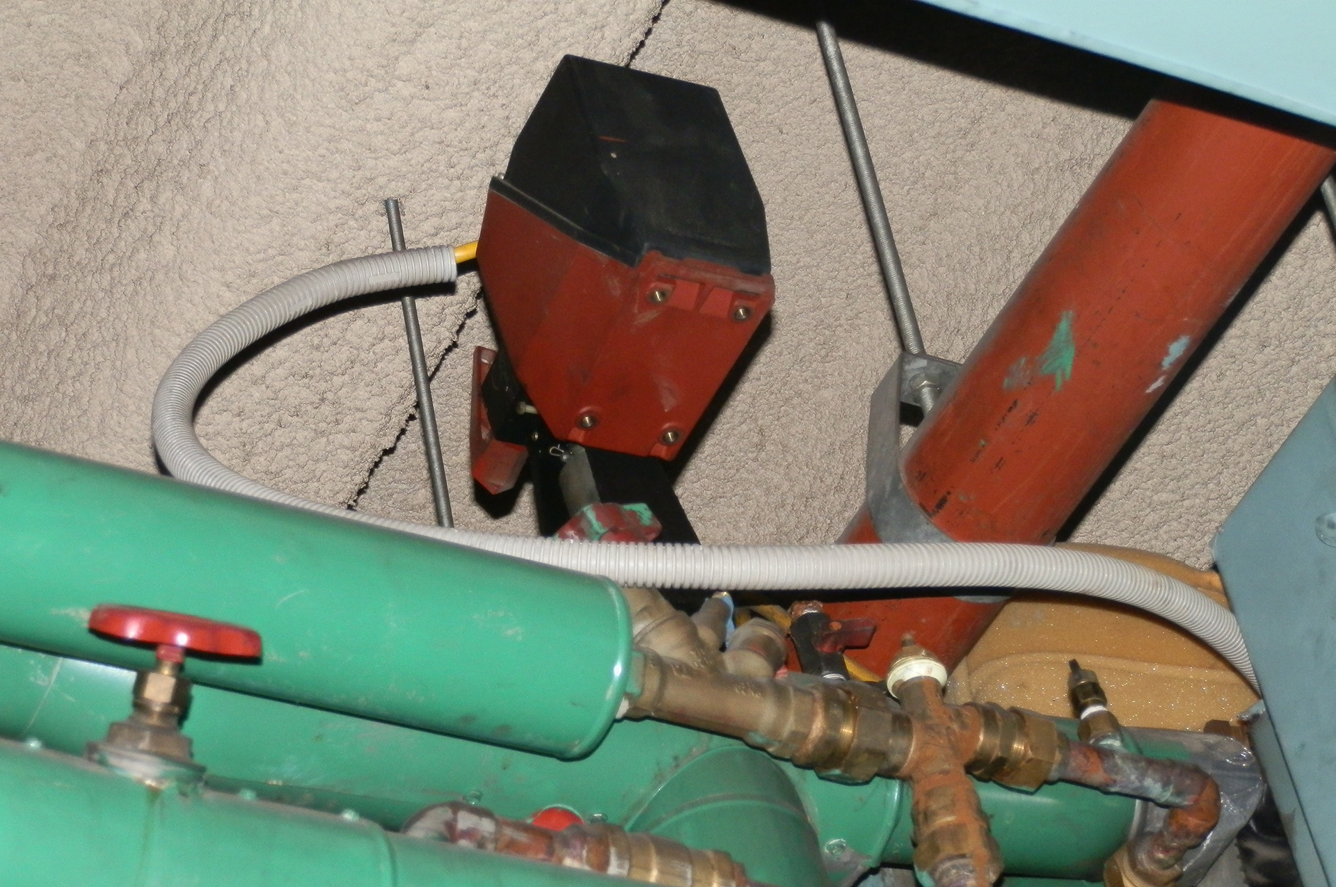 Old Tour & Andersson control valve and actuator regulating chilled-water flow to a packaged air-conditioning unit in a Sydney building.