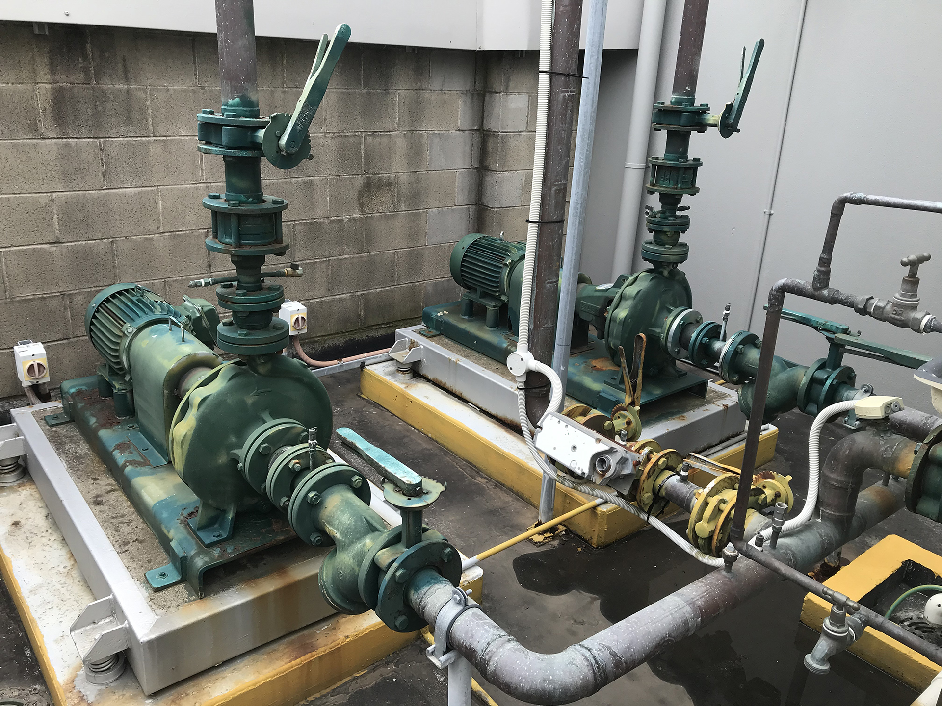 Condenser water pumps with motorised bypass valve actuator connected to a Building Management System in a commercial building in Sydney.