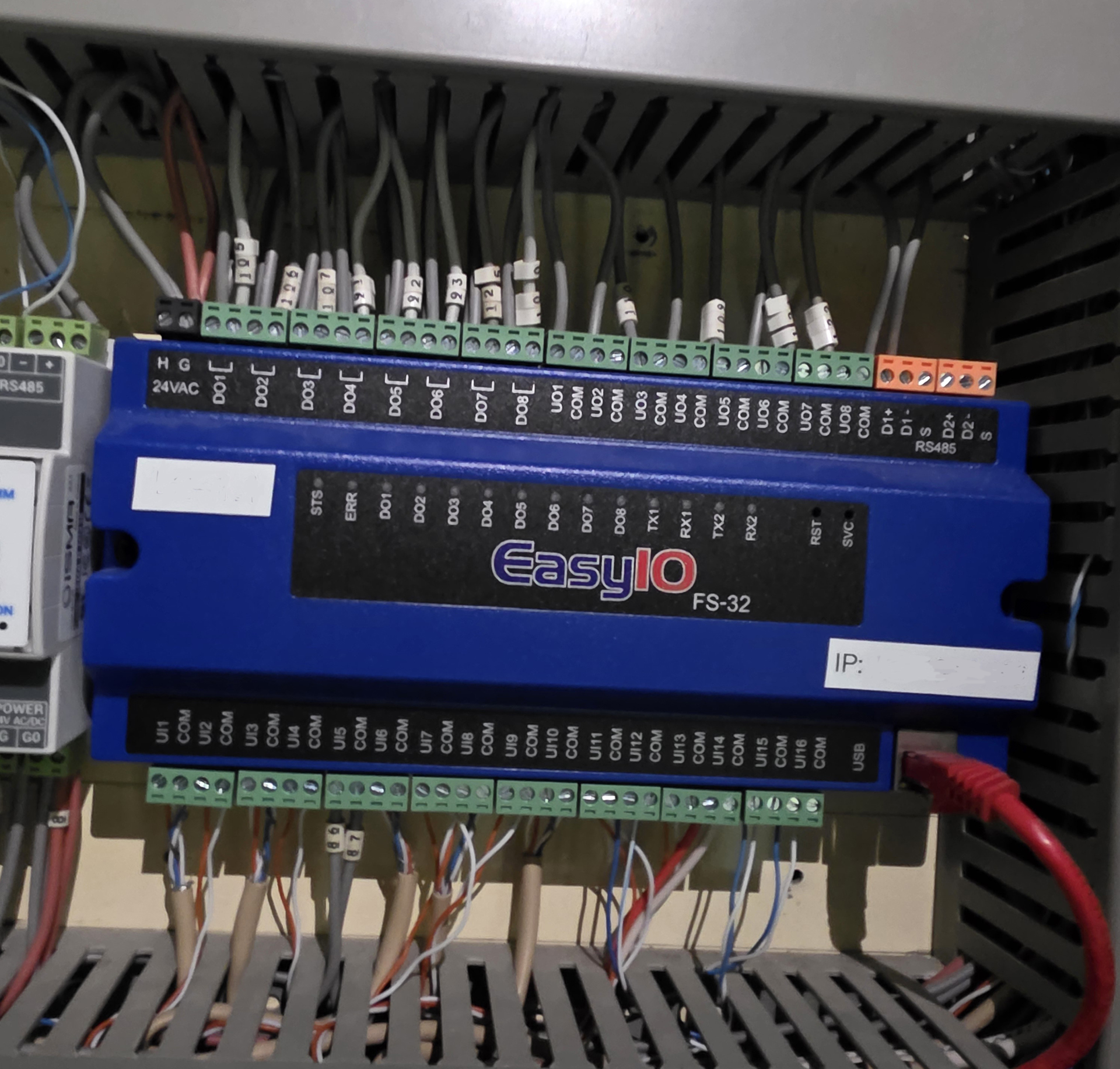 EasyIO FS-32 BACnet Building Management System controller installed inside a commercial building automation control panel for HVAC monitoring and control.