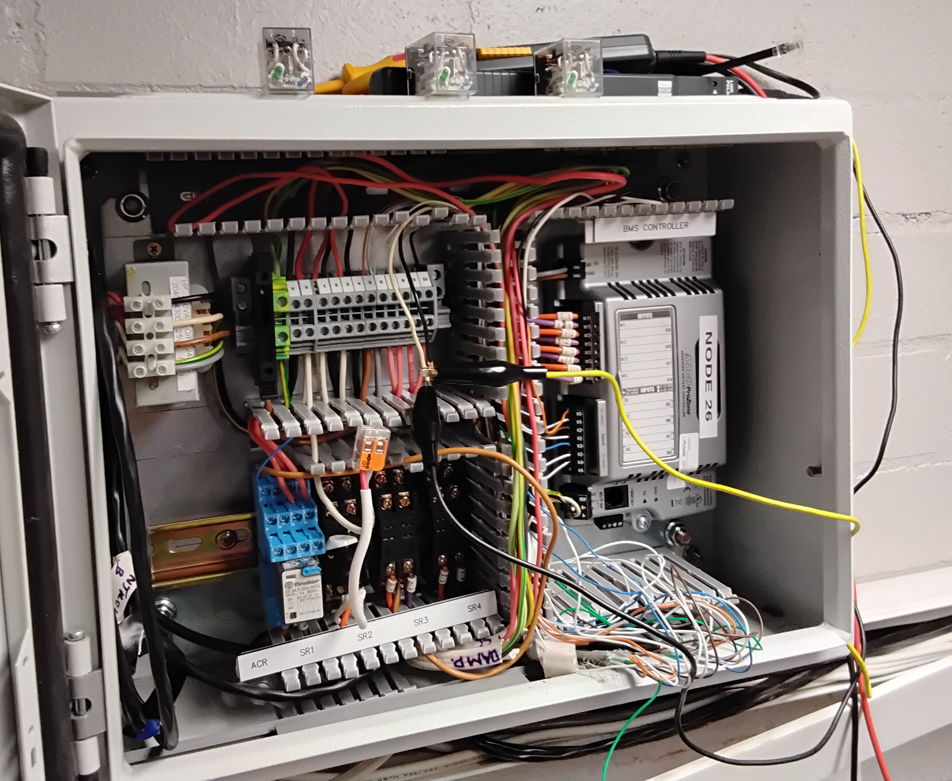 Reliable Controls BACnet Building Management System controller installed inside a commercial building automation control panel for HVAC monitoring and control in Sydney.